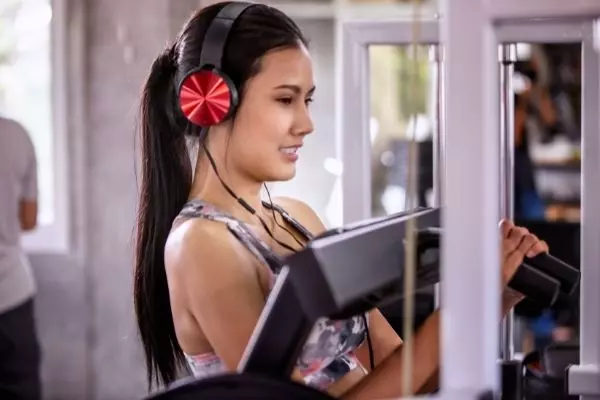 An Image Of A Girl Doing Workout With Headphones On.