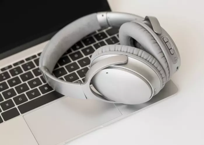 A Picture Of A Wireless Headphone On A MacBook